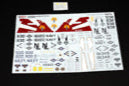 Set of model building decals with red and white design on a black background